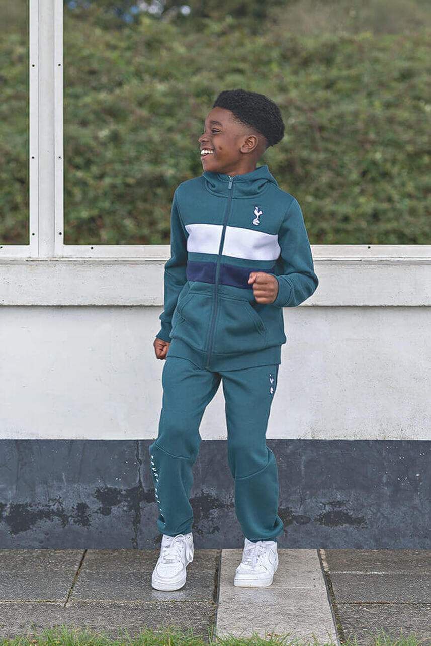 a male child model wearing a green tracksuit