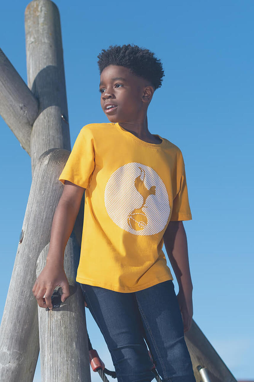 a male child model wearing a yellow tee shirt