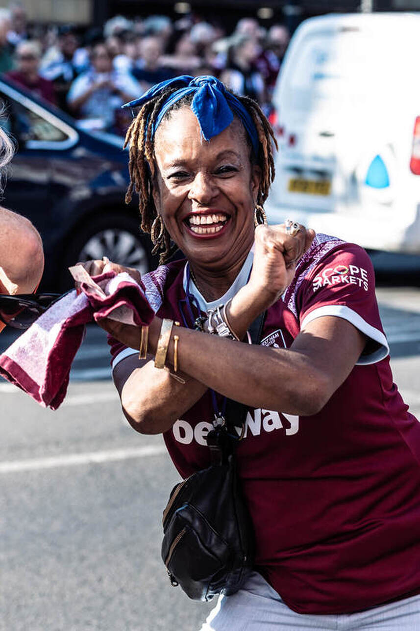 a west ham fan celebrating winning the europa cup