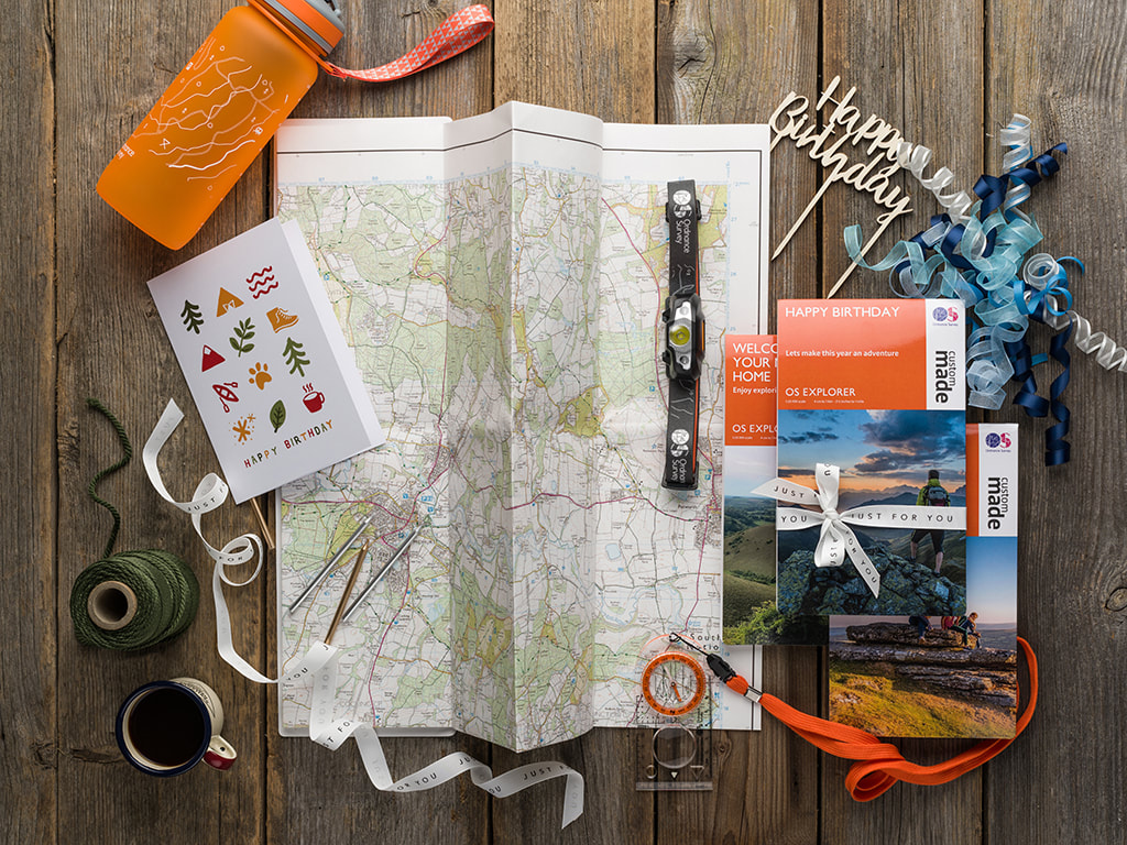 sordnace survey maps photographed froma bove and styled with happy birthday items